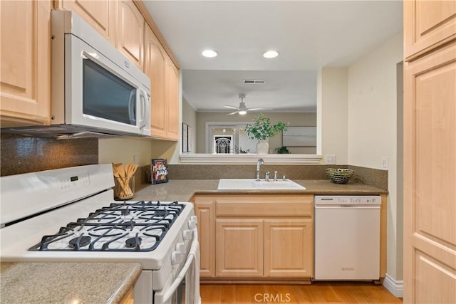 kitchen featuring ceiling fan, light brown cabinets, white appliances, light wood-type flooring, and sink