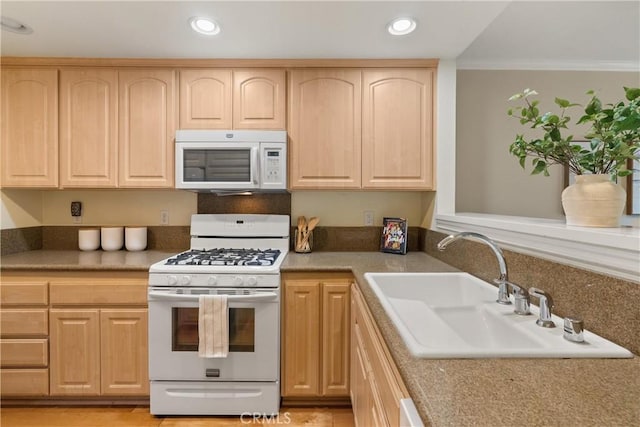 kitchen featuring light brown cabinetry, sink, white appliances, and ornamental molding