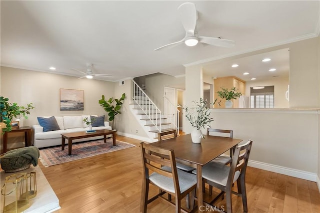 dining area featuring ceiling fan, crown molding, and light hardwood / wood-style flooring