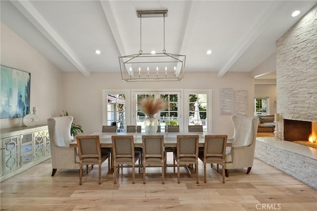 dining room featuring vaulted ceiling with beams, light wood finished floors, a fireplace, and recessed lighting