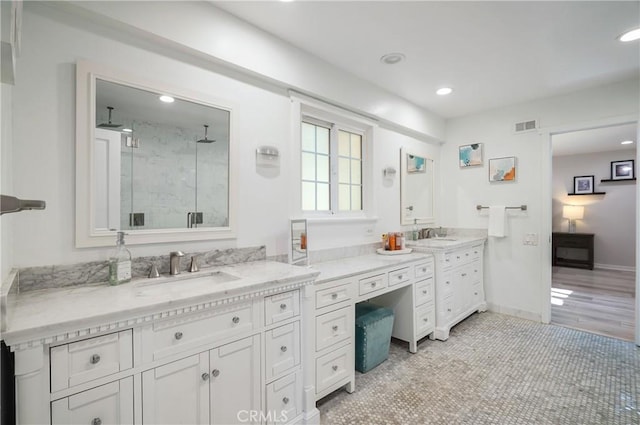 full bathroom featuring recessed lighting, a sink, visible vents, double vanity, and a stall shower