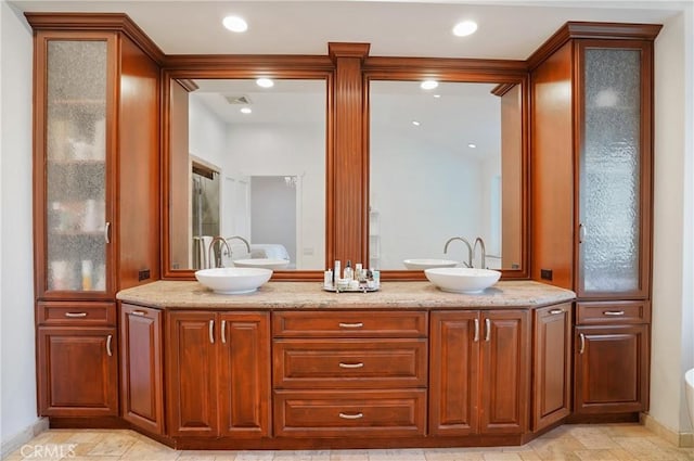 bathroom featuring double vanity, a sink, visible vents, and recessed lighting