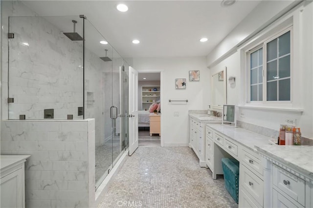 ensuite bathroom featuring ensuite bathroom, tile patterned flooring, recessed lighting, vanity, and a shower stall