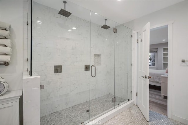 full bathroom featuring ensuite bathroom, a stall shower, and tile patterned floors