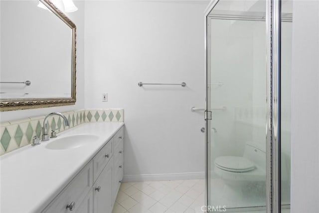 bathroom featuring toilet, tile patterned floors, vanity, and a shower with shower door