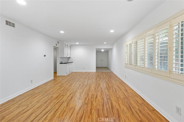 unfurnished living room with light wood-type flooring