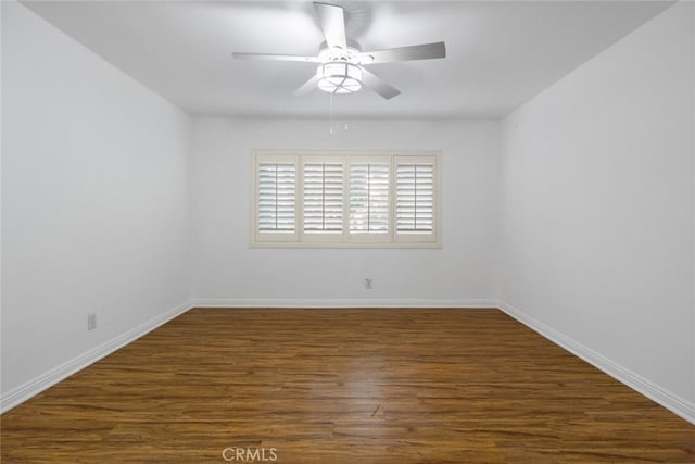 spare room with ceiling fan and dark hardwood / wood-style floors