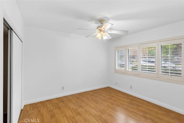 unfurnished bedroom with ceiling fan, a closet, and light hardwood / wood-style flooring