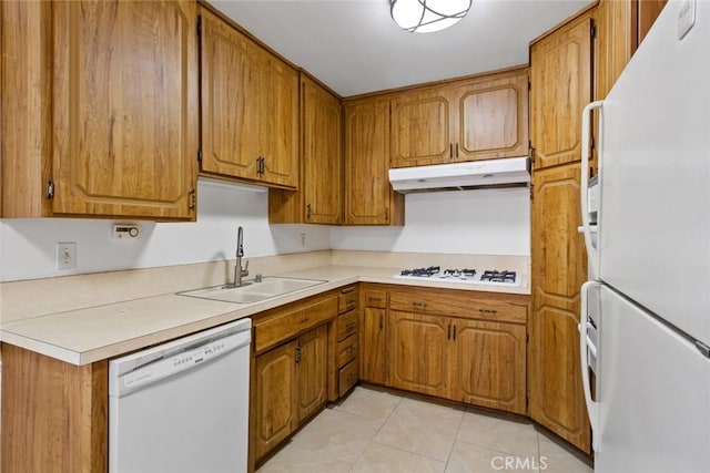 kitchen with light tile patterned floors, sink, and white appliances