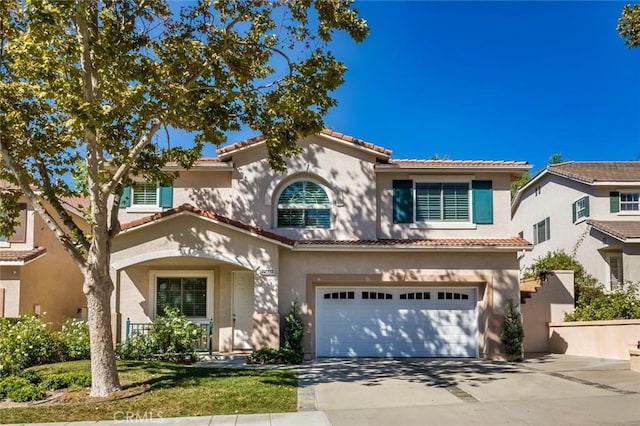 mediterranean / spanish-style home with a garage