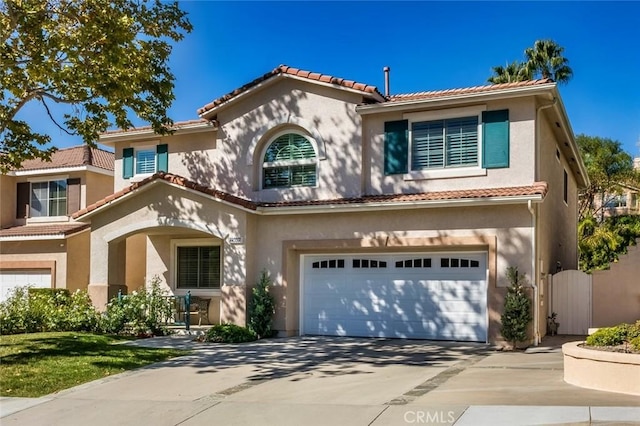 mediterranean / spanish home featuring a garage