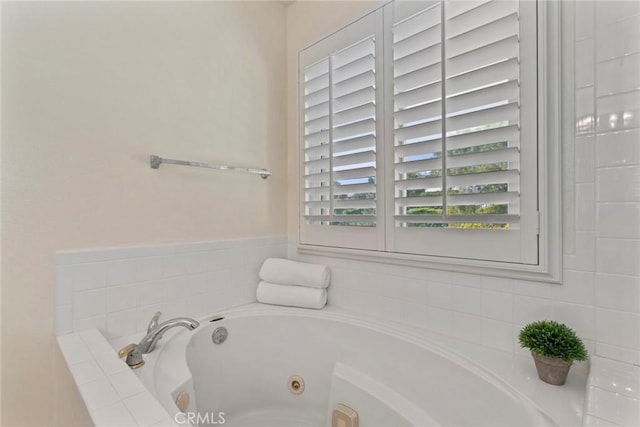 bathroom featuring tiled bath