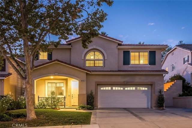 mediterranean / spanish-style house with a garage