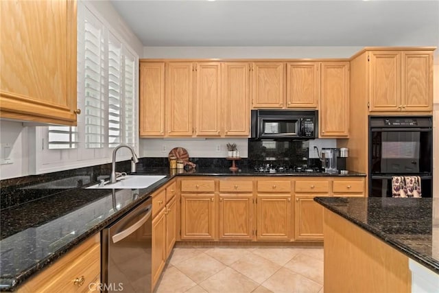 kitchen with black appliances, light tile patterned floors, dark stone counters, and sink