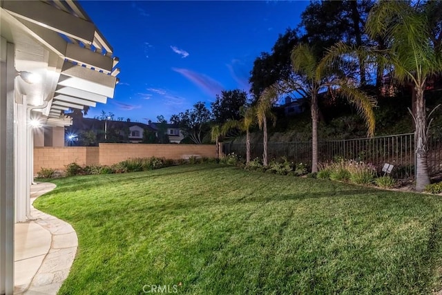 view of yard at dusk