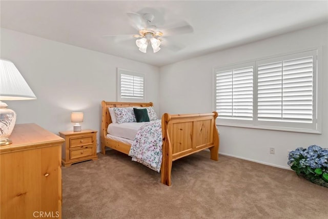 bedroom with ceiling fan, multiple windows, and carpet flooring