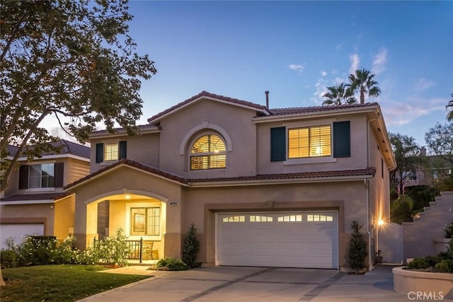 mediterranean / spanish-style home featuring a garage