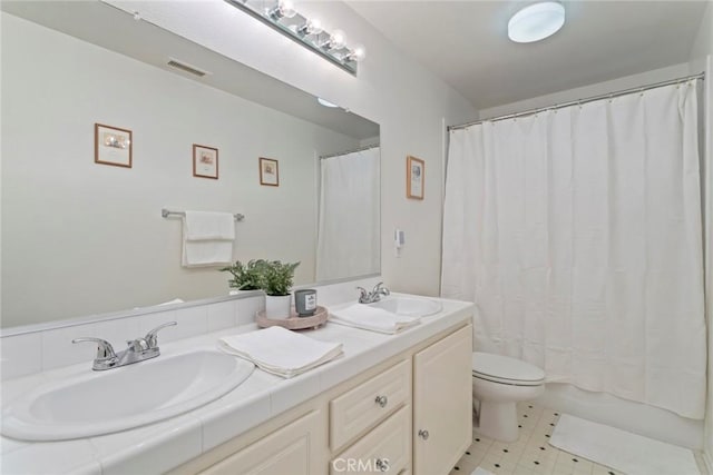 bathroom with toilet and vanity