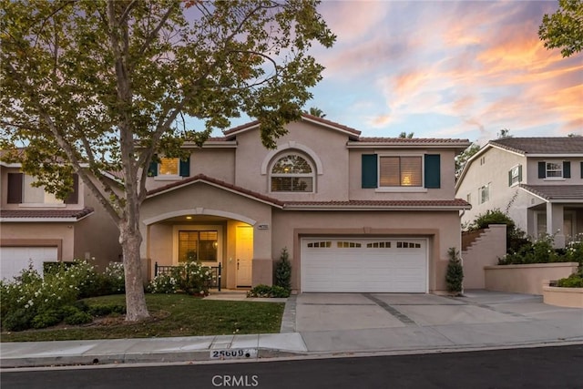 mediterranean / spanish-style home featuring a garage