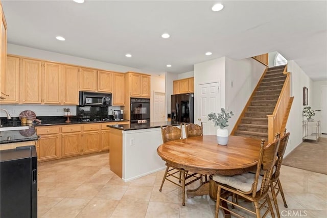 kitchen with black appliances, a center island, light brown cabinetry, decorative backsplash, and light tile patterned floors