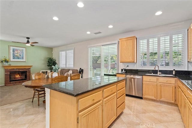 kitchen with ceiling fan, light brown cabinets, dishwasher, and a kitchen island