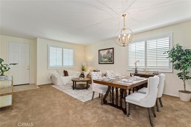 dining room with an inviting chandelier, a healthy amount of sunlight, and carpet floors