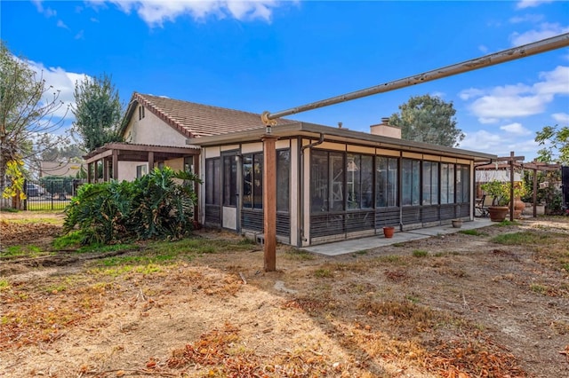 back of house with a sunroom