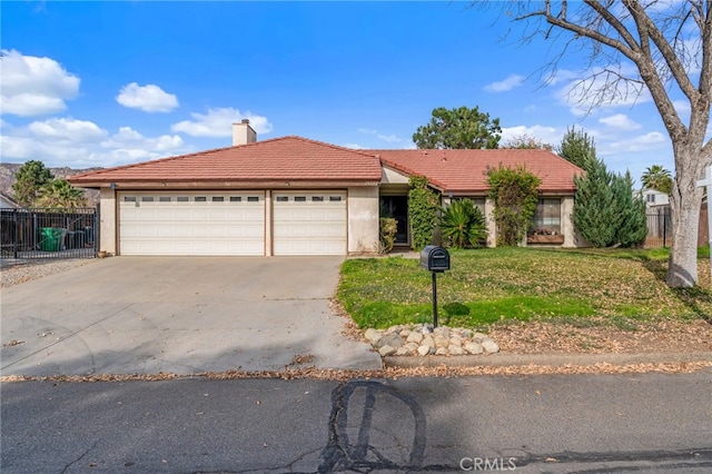 view of front of property featuring a garage and a front lawn