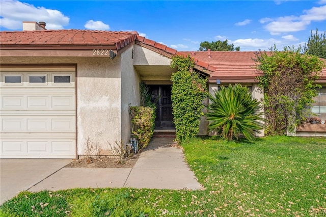 exterior space with a yard and a garage