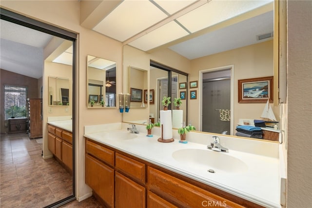 bathroom featuring an enclosed shower, vanity, and lofted ceiling