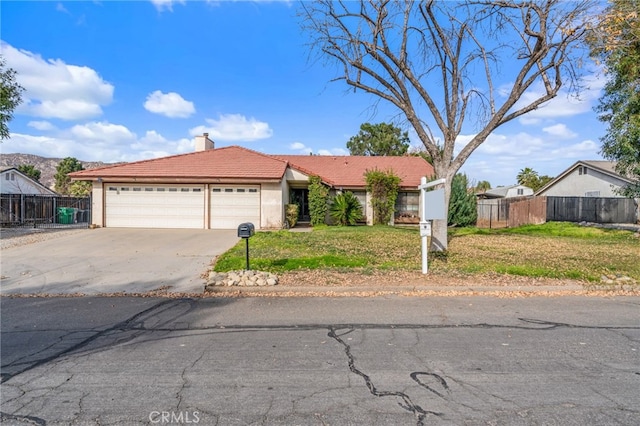 single story home featuring a garage and a front yard