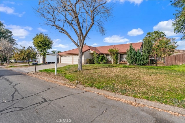 ranch-style home with a garage and a front lawn