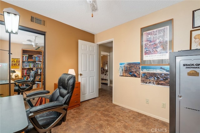 office area with a textured ceiling and ceiling fan