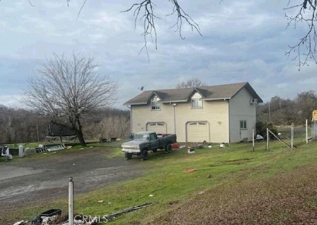 view of side of property with a garage and a yard