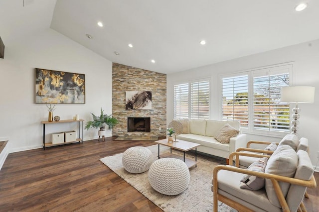 living room with hardwood / wood-style floors, lofted ceiling, and a fireplace