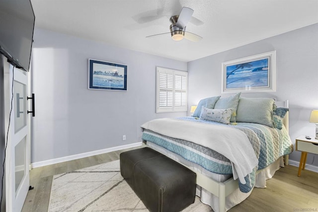 bedroom featuring ceiling fan and light hardwood / wood-style flooring