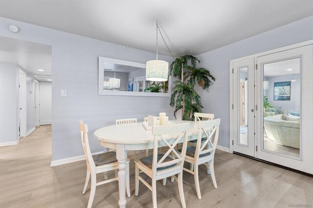 dining space with light hardwood / wood-style floors