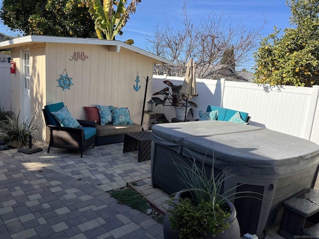 view of patio / terrace featuring an outdoor living space and a hot tub