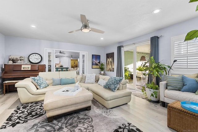 living room with ceiling fan, a healthy amount of sunlight, and light hardwood / wood-style floors