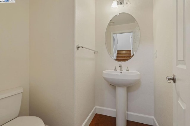 bathroom featuring toilet and hardwood / wood-style flooring