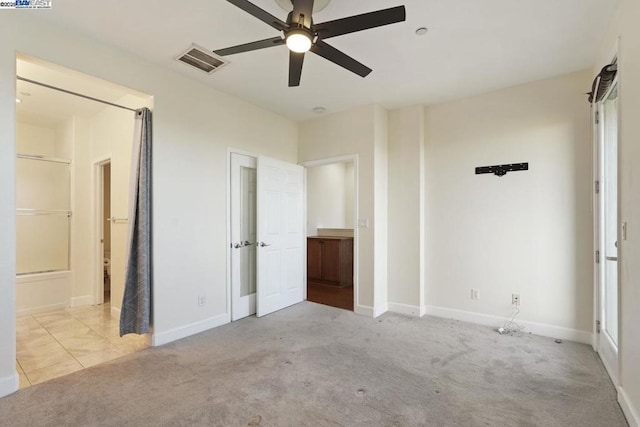 unfurnished bedroom with ceiling fan and light colored carpet