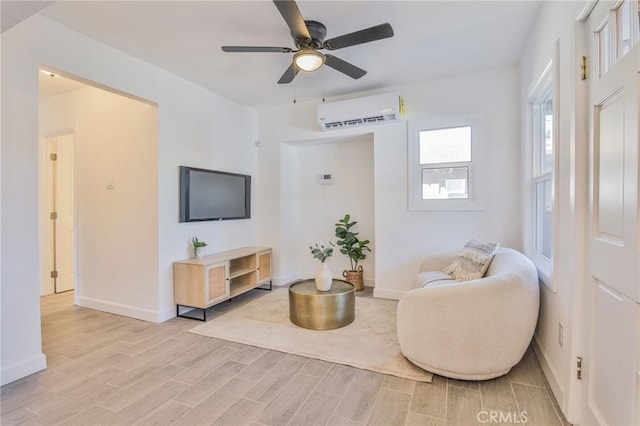 sitting room featuring ceiling fan and a wall unit AC