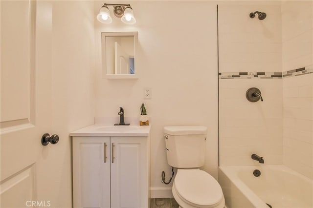 full bathroom featuring toilet, tiled shower / bath, and vanity