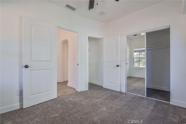 unfurnished bedroom featuring ceiling fan, a closet, and carpet