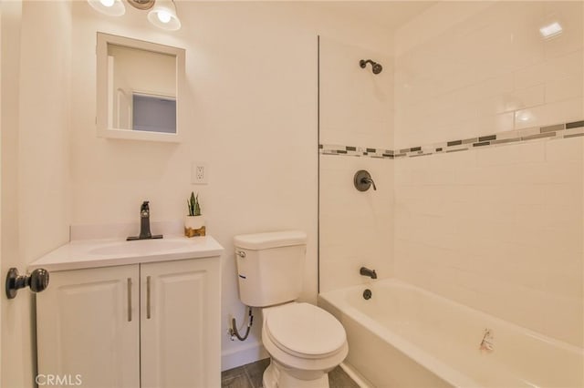 full bathroom featuring toilet, tiled shower / bath, and vanity