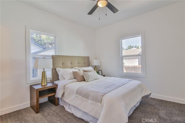 bedroom with ceiling fan, carpet flooring, and multiple windows