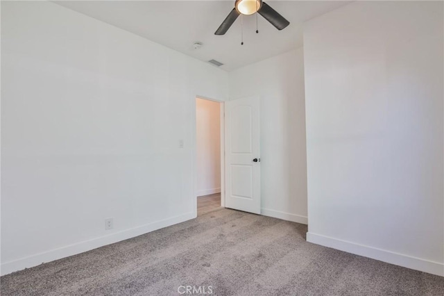 carpeted spare room with ceiling fan