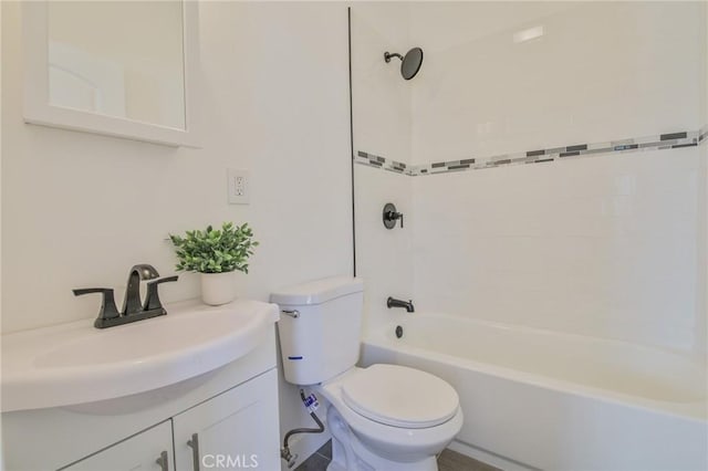 full bathroom with toilet, vanity, and tiled shower / bath