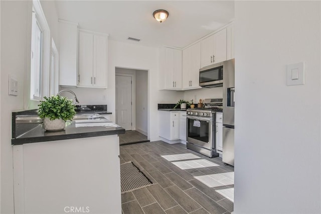 kitchen with sink, white cabinetry, and appliances with stainless steel finishes