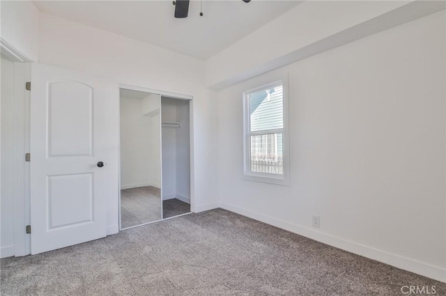 unfurnished bedroom with ceiling fan, light colored carpet, and a closet